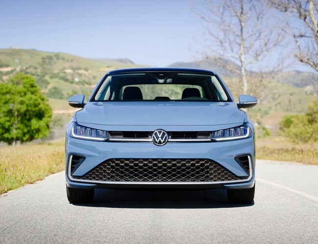 Light blue Volkswagen Jetta, head-on view.